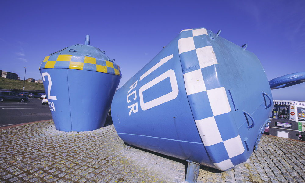 IMG_9697-buoys View at North Shields Fish Quay, shows large blue buoys on the path.